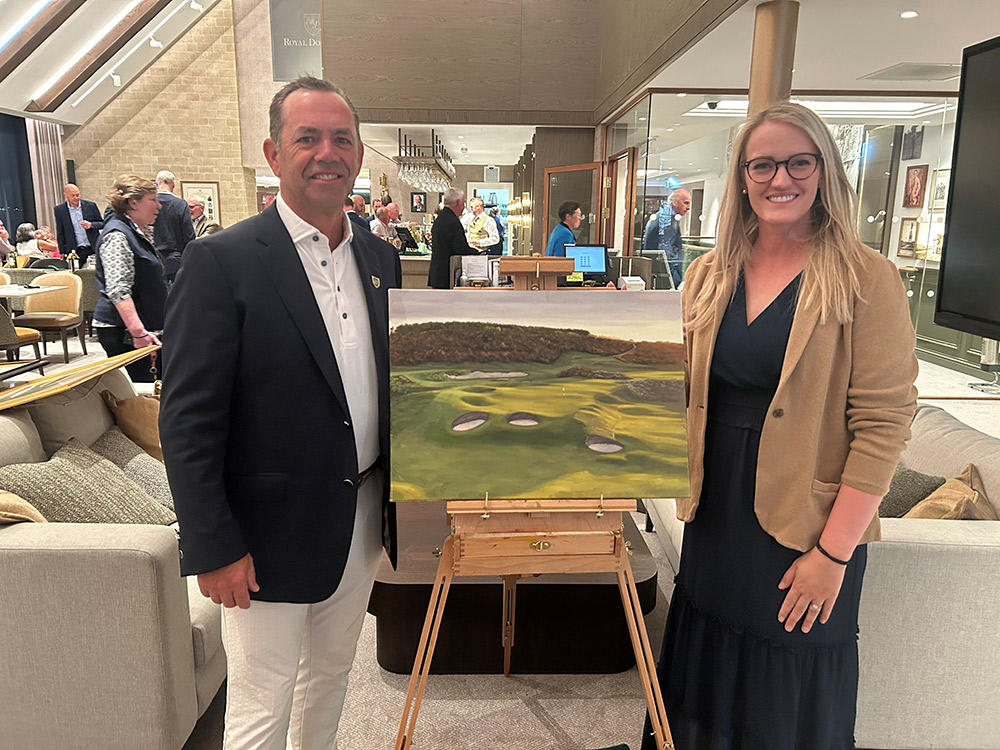 Aimee Smith pictured with Phil Leonard, who was gifted the painting by the successful bidder