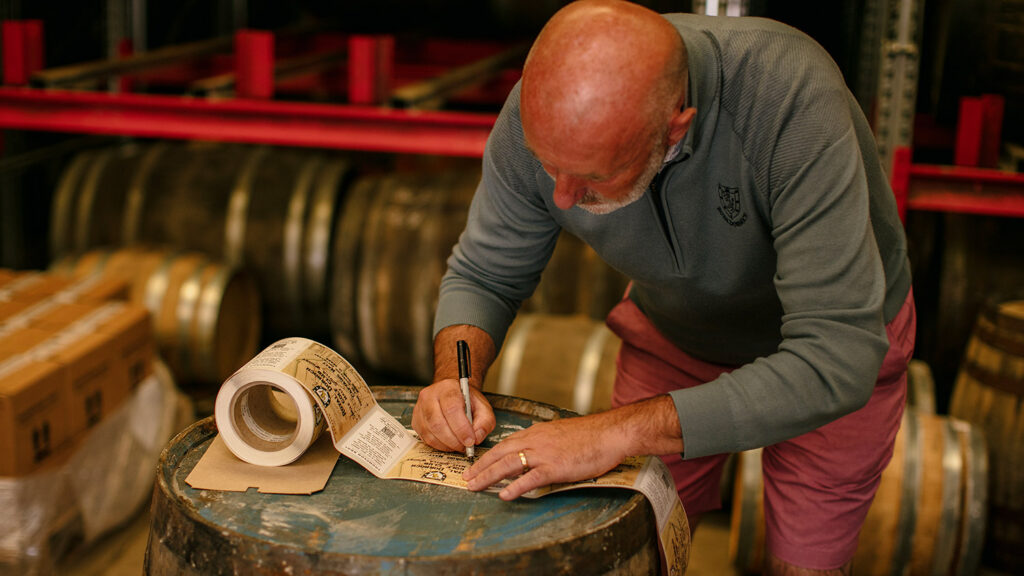 Royal Dornoch Captain Gary Bethune signing every bottle label.